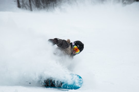 man snowboarding at daytime in Revelstoke Mountain Resort Canada