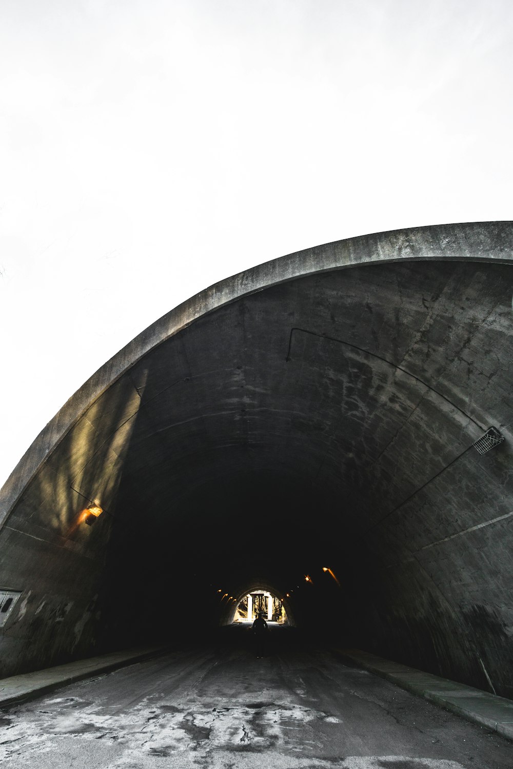 empty tunnel with lights at daytime