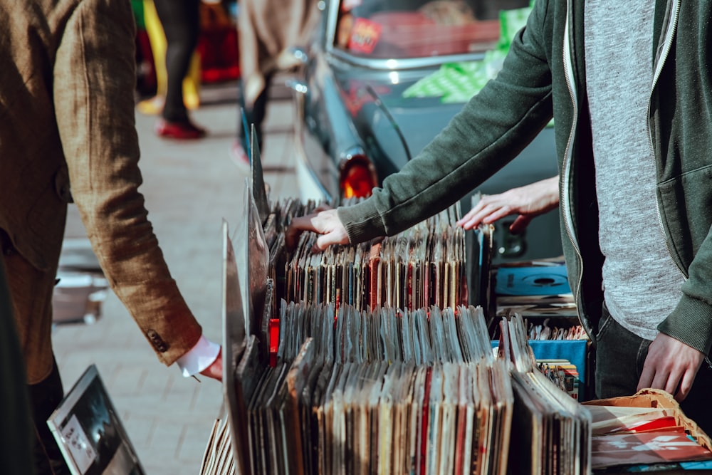 People browsing vinyl records at a stall on the street