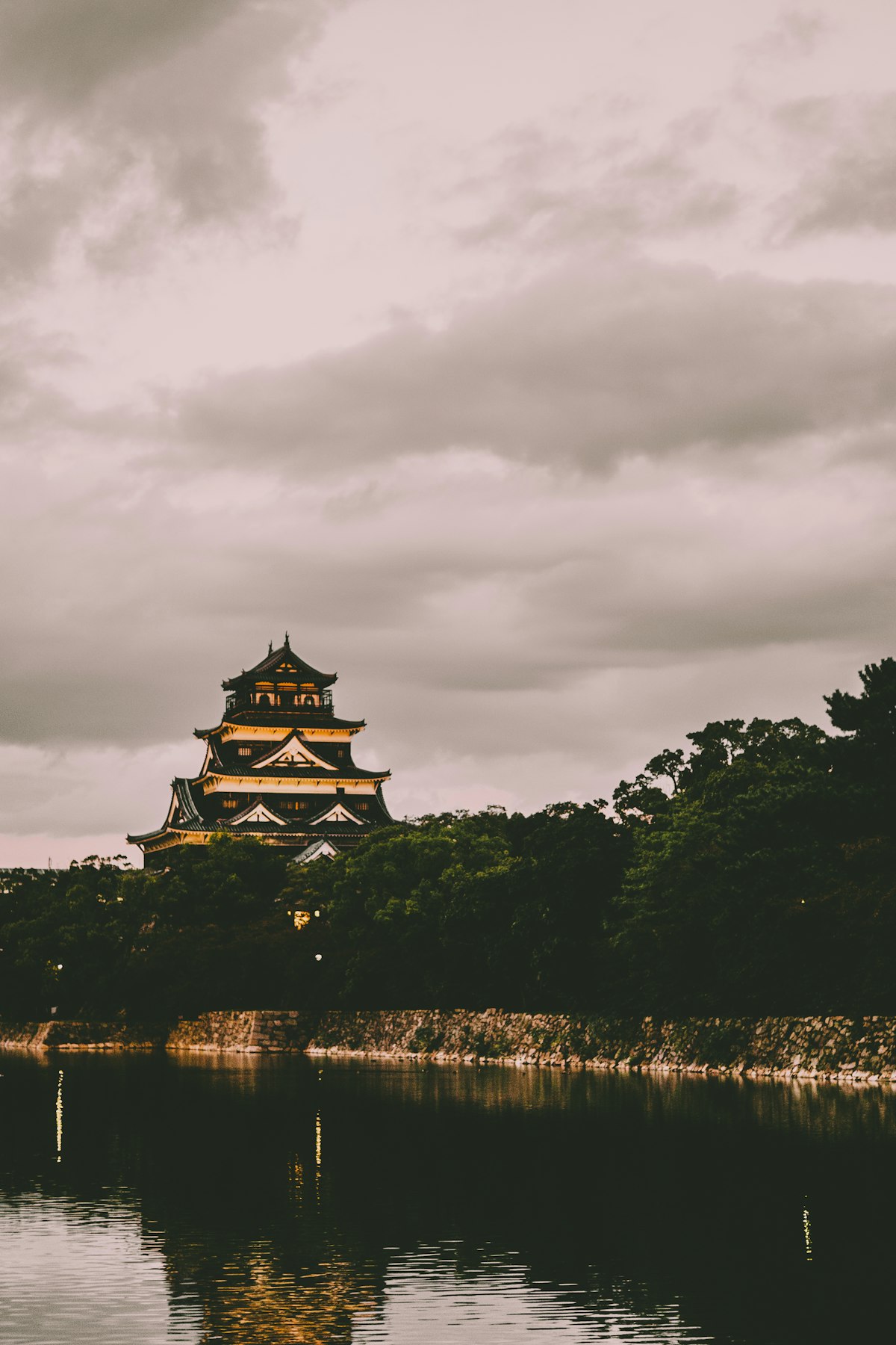 Hiroshima Castle rising above green hillside trees, Hiroshima