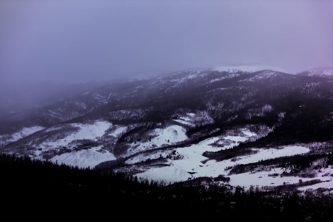 aerial photography of snowfield under white clouds