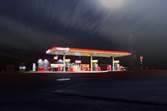 Circle gas station along the road during night time