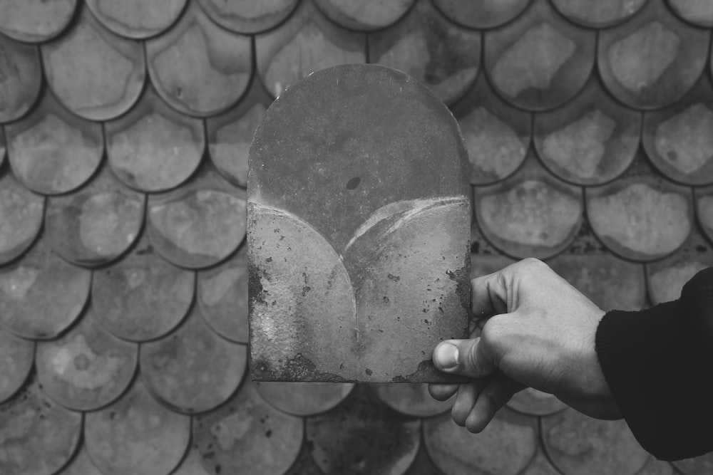 person holding heart shaped red and white heart shaped decor