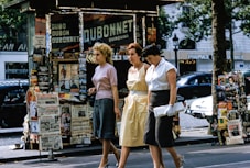 three women walking on road