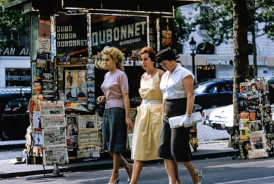 three women walking on road