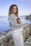 woman in white near calm body of water