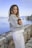 woman in white near calm body of water