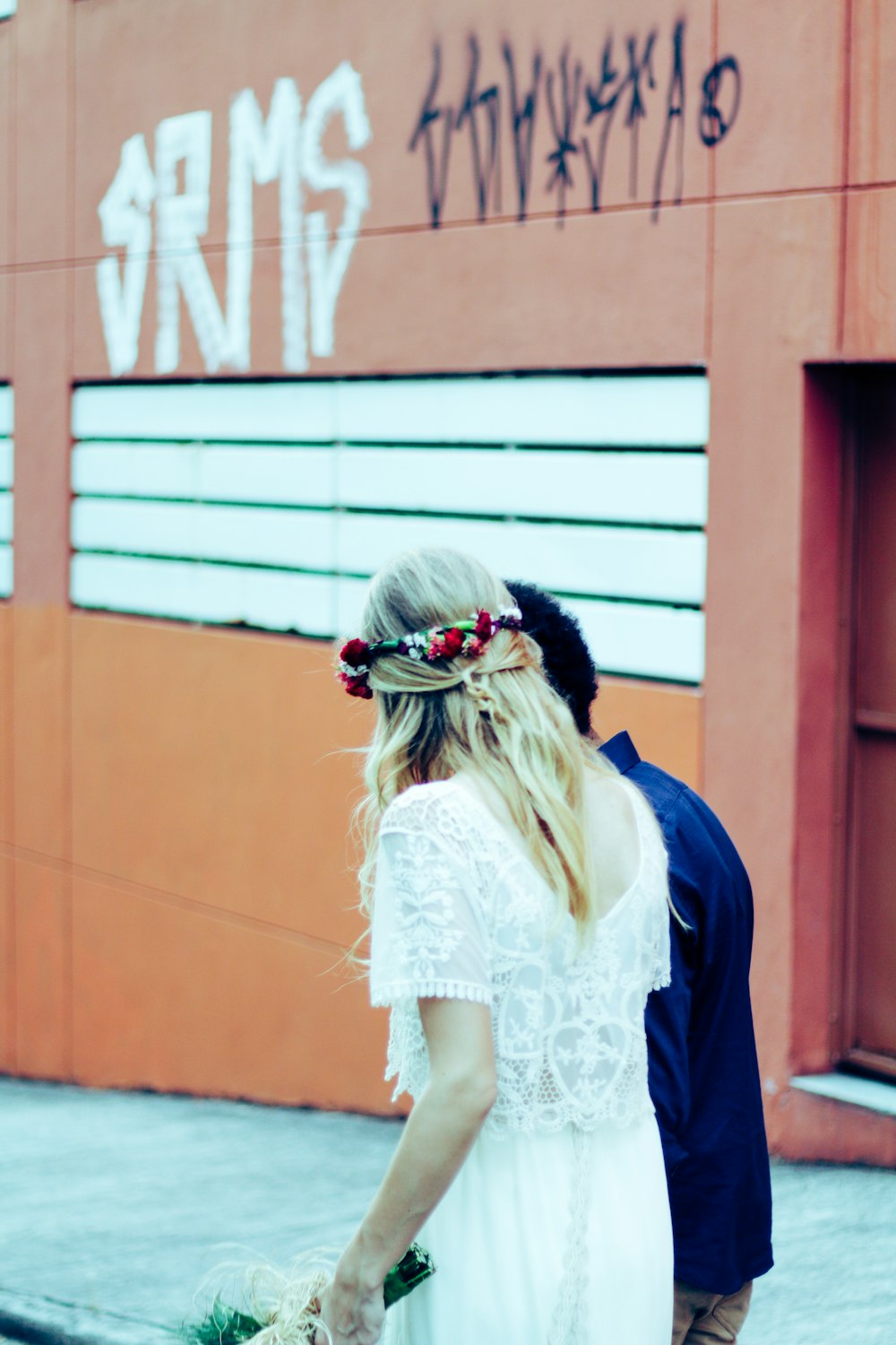 woman and man standing near wall