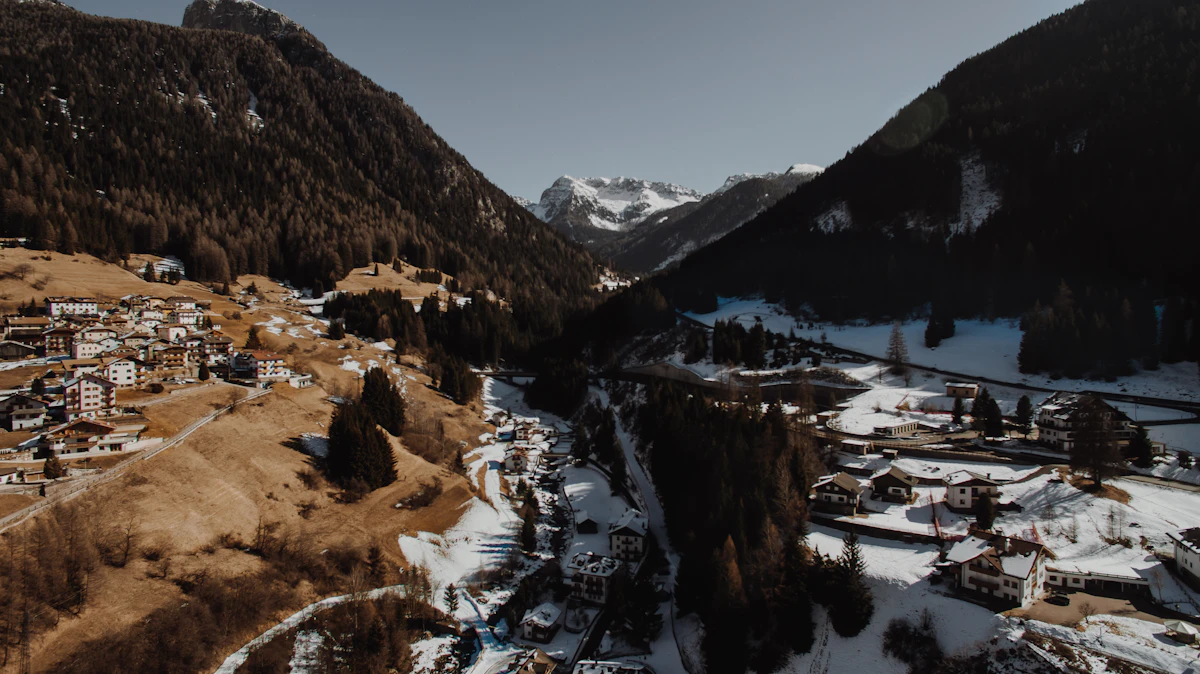 Aerial view of a village spread along a snowy mountain valley