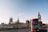 red double-decker bus passing Palace of Westminster, London during daytime
