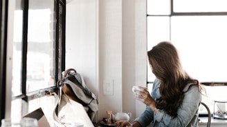 man holding white ceramic teacup