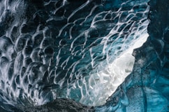 a large ice cave with water flowing down it