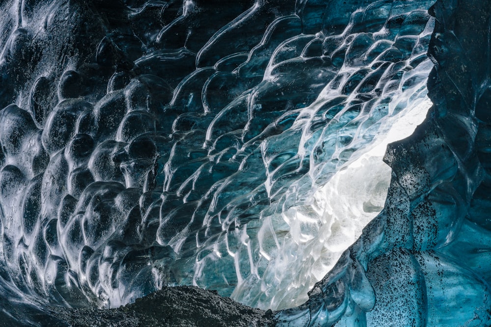 a large ice cave with water flowing down it