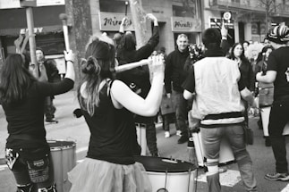 A vibrant image of a djembe drum surrounded by community members.