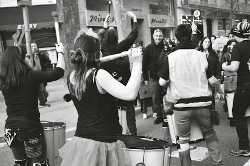 A vibrant image of a djembe drum surrounded by community members.