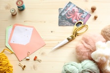 silver scissors on pink paper
