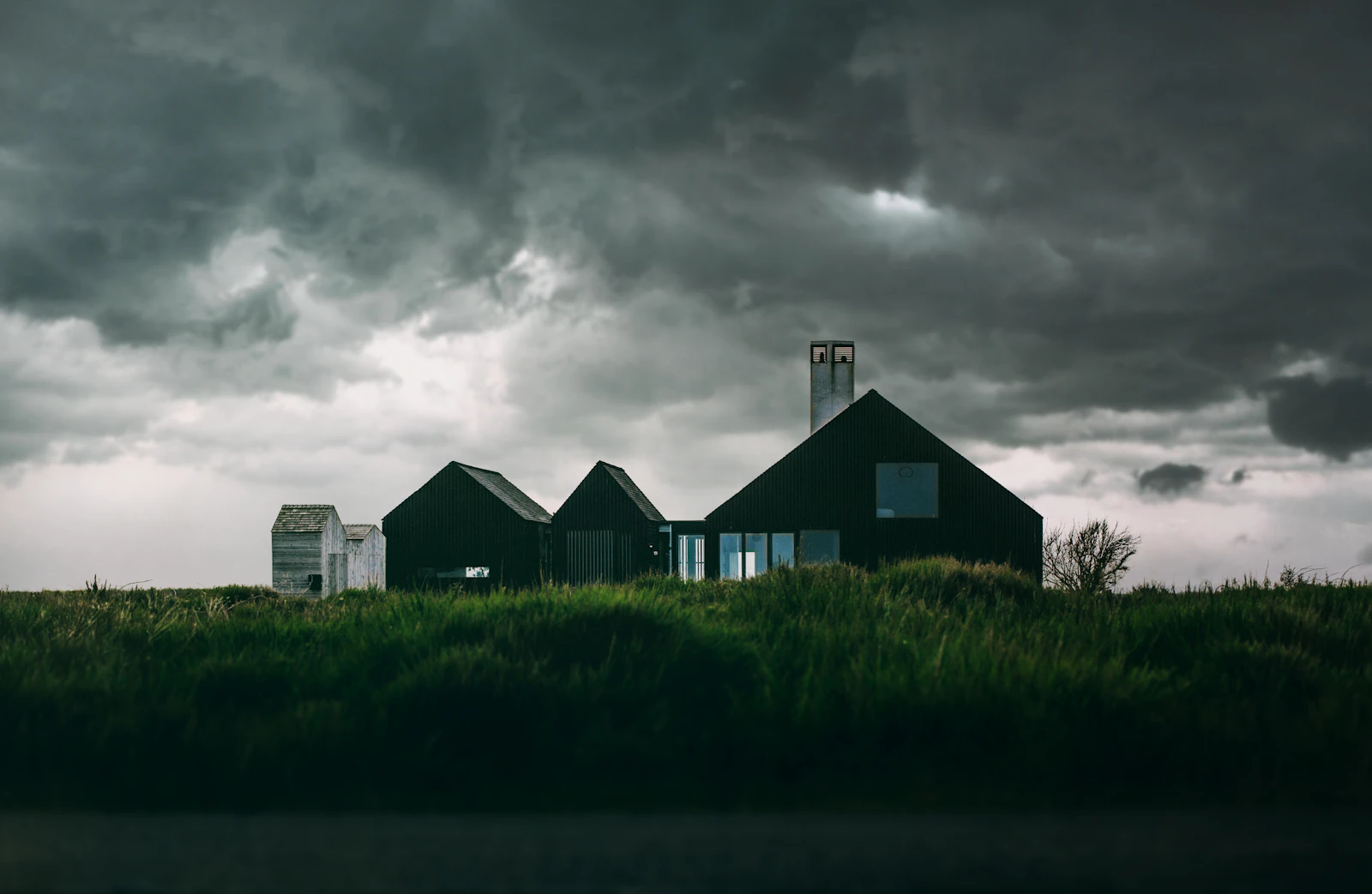 A house beneath dramatic storm clouds