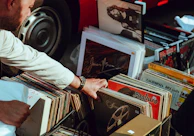 person holding vinyl records