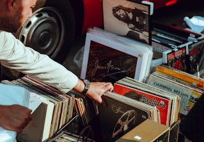 person holding vinyl records