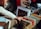 A person using a smartphone app to check vinyl record values.