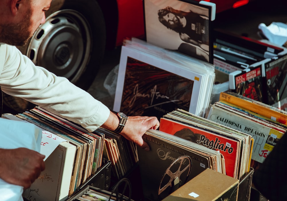 Person going through a box of records, looking for royalty free music