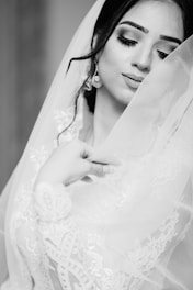 woman in white wedding dress closing eyes