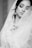 woman in white wedding dress closing eyes