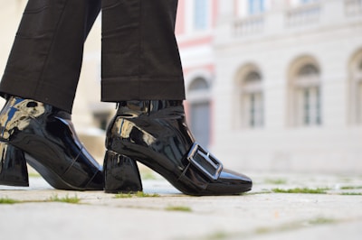 A model wearing sophisticated shoes in an urban setting.