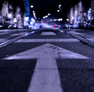 shallow focus photography of road with forward arrow illustration