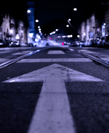 shallow focus photography of road with forward arrow illustration