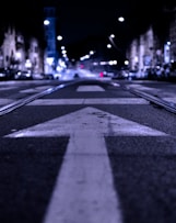 shallow focus photography of road with forward arrow illustration