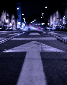 shallow focus photography of road with forward arrow illustration