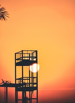 silhouette of watch tower during golden hour