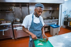 man chopping garlic gloves