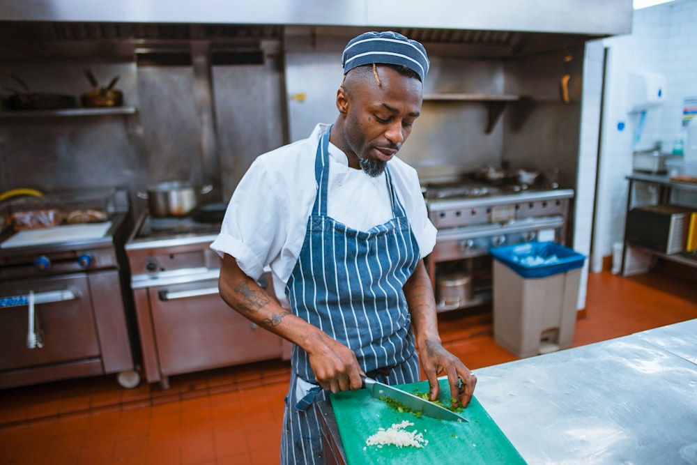 man chopping garlic gloves