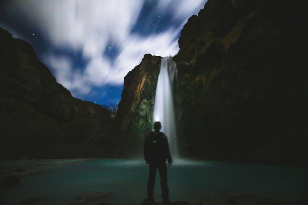 man standing in front of body of water