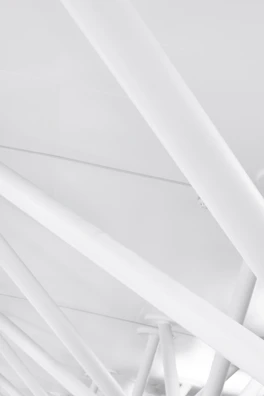 Steel beams arranged in a complex architectural pattern inside a warehouse.