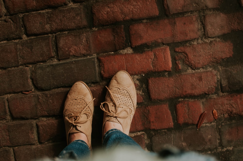 person standing on brick pavement