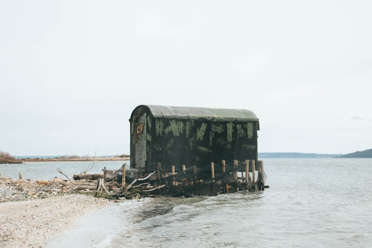 brown and gray shed on body of water in Saint-Chamas France