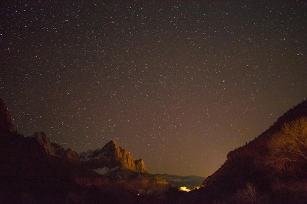 A starry night sky over a mountain range.