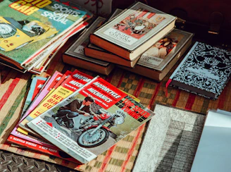 Close-up of old yearbooks and memorabilia spread out on a table, sparking nostalgia.