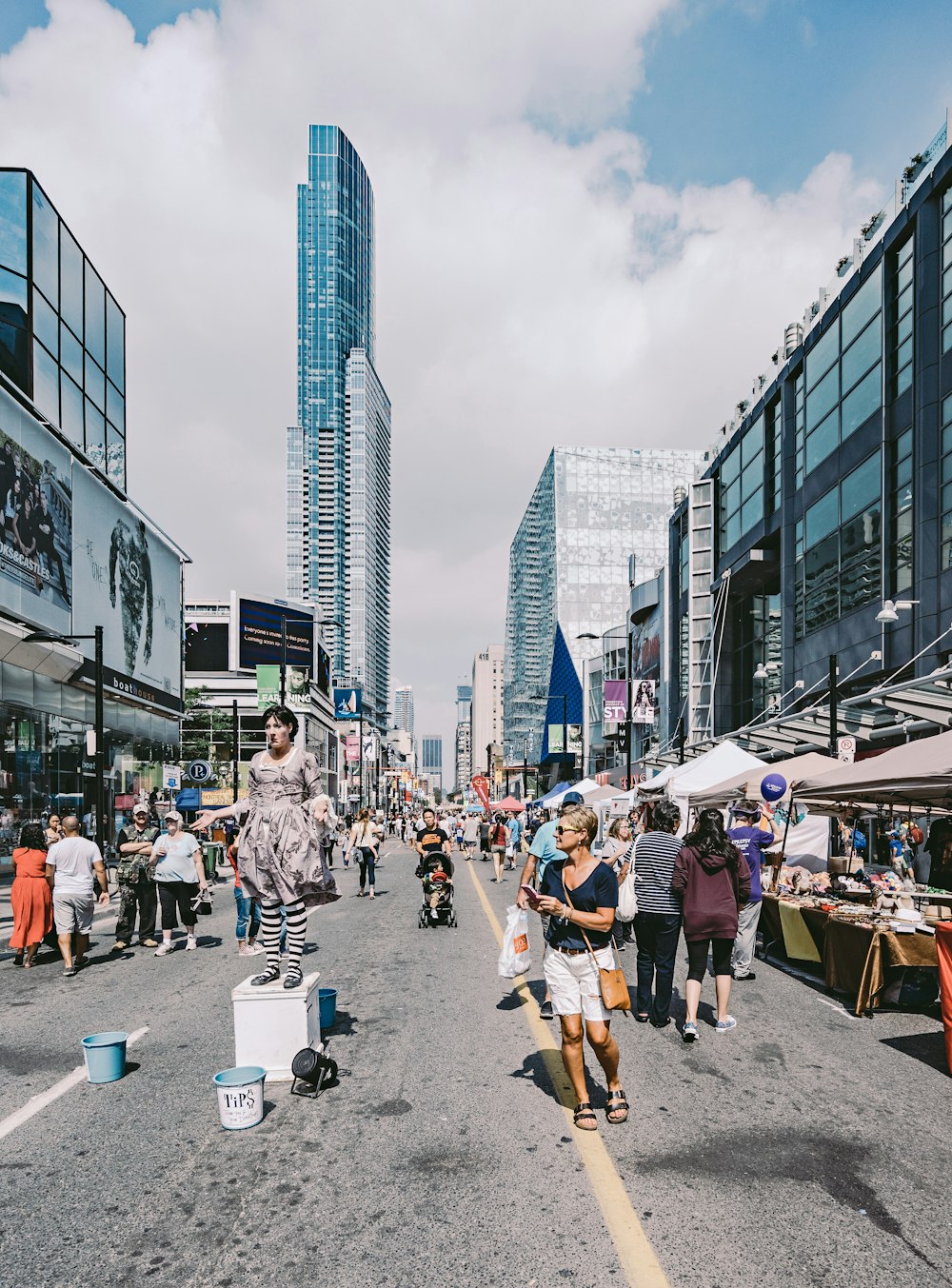 people walking on street beside buildings