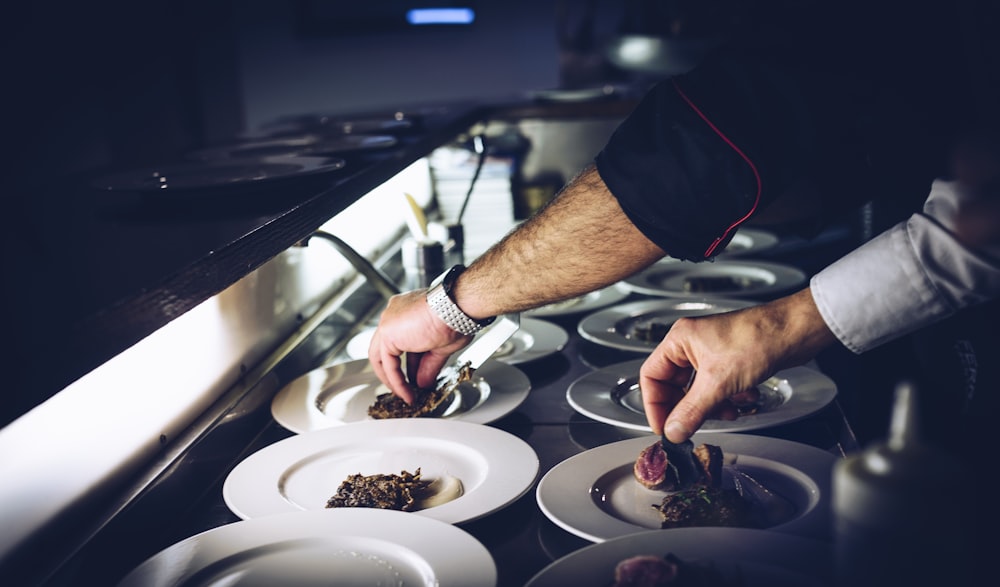 person preparing cooked dish