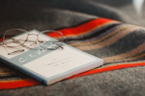 gray framed eyeglasses on book