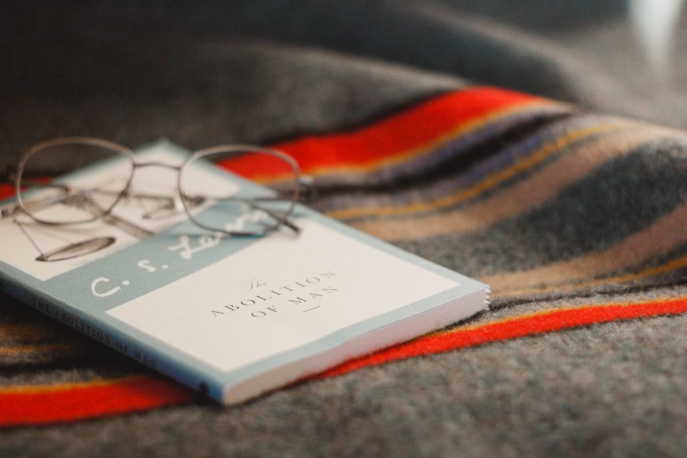 gray framed eyeglasses on book