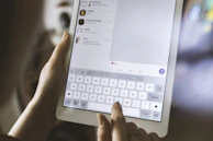 person using white iPad