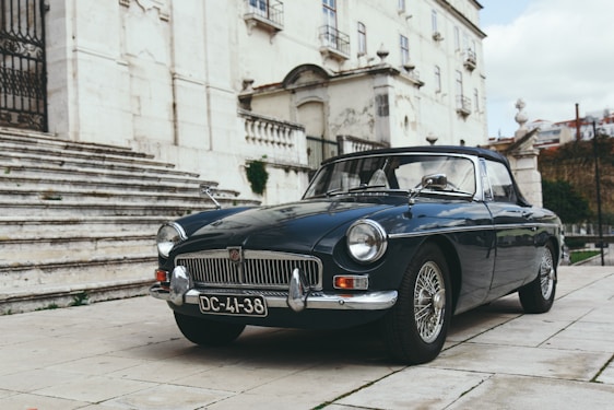 blue coupe near gray concrete staircase