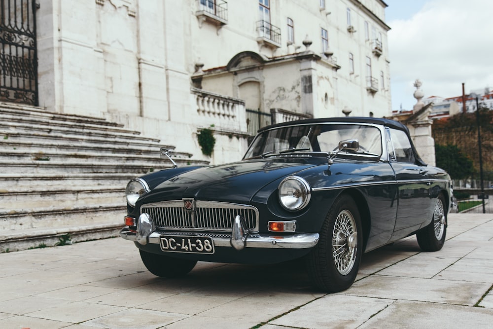 coupé blu vicino alla scala di cemento grigio