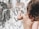 A joyful child painting on a canvas in a bright studio.