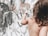 A joyful child painting on a canvas in a bright studio.